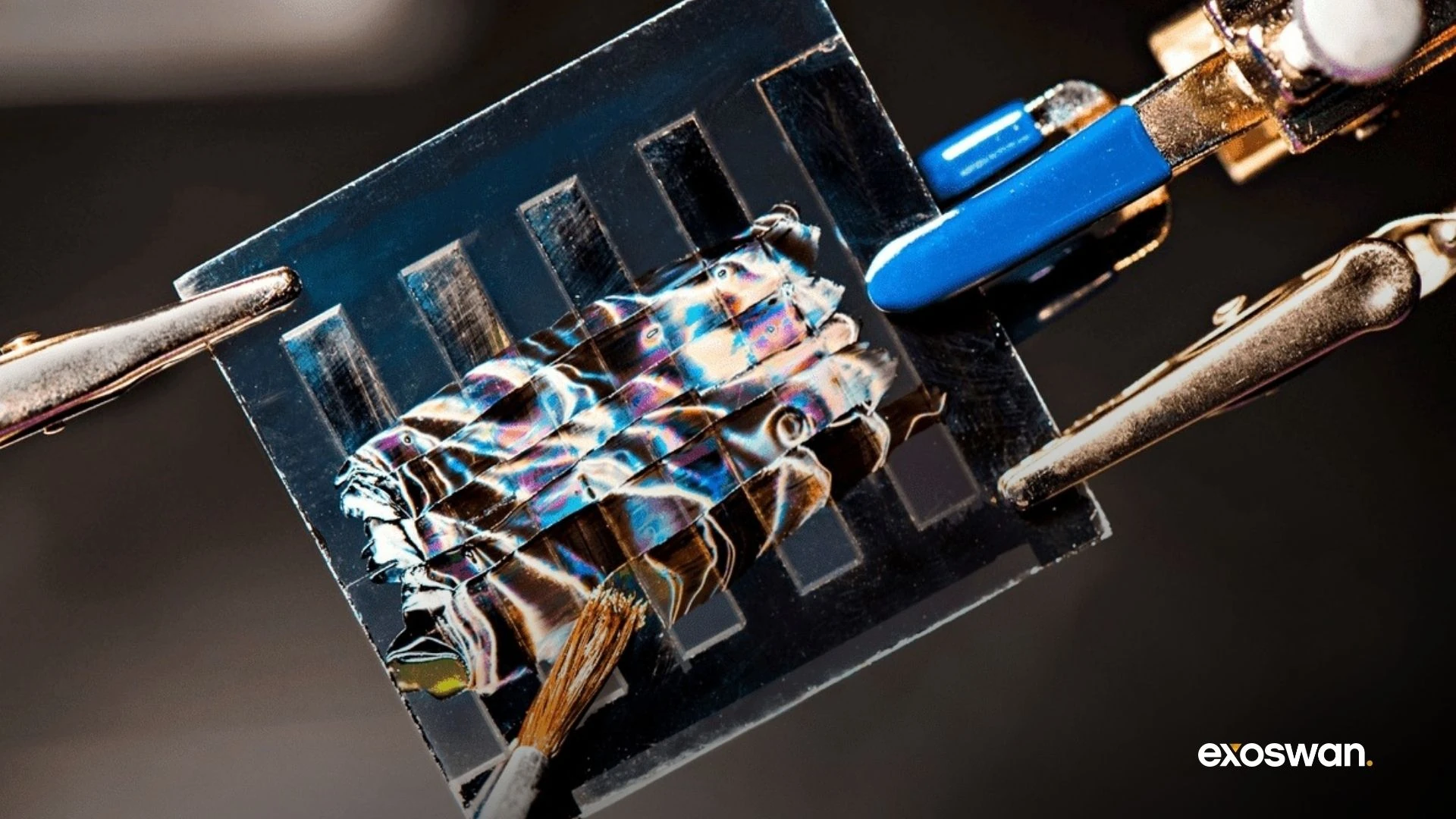 Perovskite solar-cell sample held by laboratory clips.